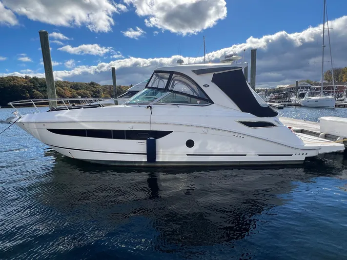  Yacht Photos Pics 2018 Sea Ray 350 Sundancer yacht docked in a marina under a partly cloudy sky.