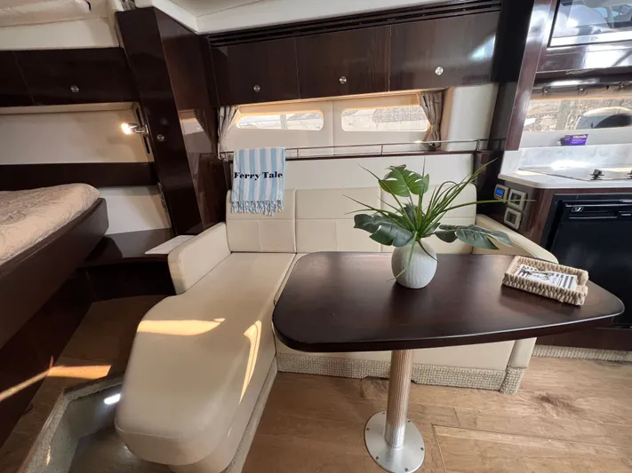  Yacht Photos Pics Interior of 2018 Sea Ray 350 Sundancer with elegant seating and table setup.