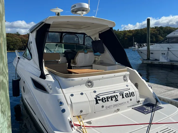  Yacht Photos Pics 2018 Sea Ray 350 Sundancer docked, rear view, sunny day, "Ferry Tale" name visible.