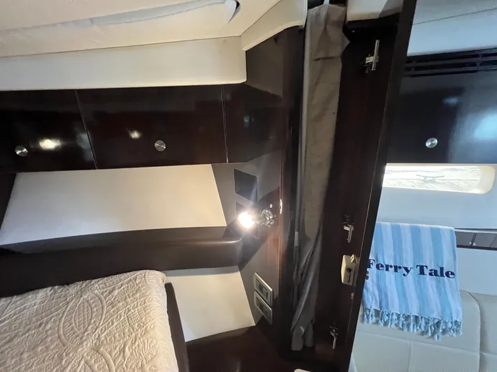  Yacht Photos Pics Interior cabin of 2018 Sea Ray 350 Sundancer with elegant wood finish and cozy bedding.