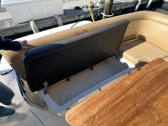  Yacht Photos Pics 2018 Sea Ray 350 Sundancer boat with open storage compartment and wooden table.