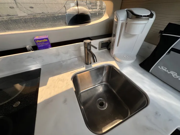  Yacht Photos Pics 2018 Sea Ray 350 Sundancer kitchen with sink, coffee maker, and utensils.