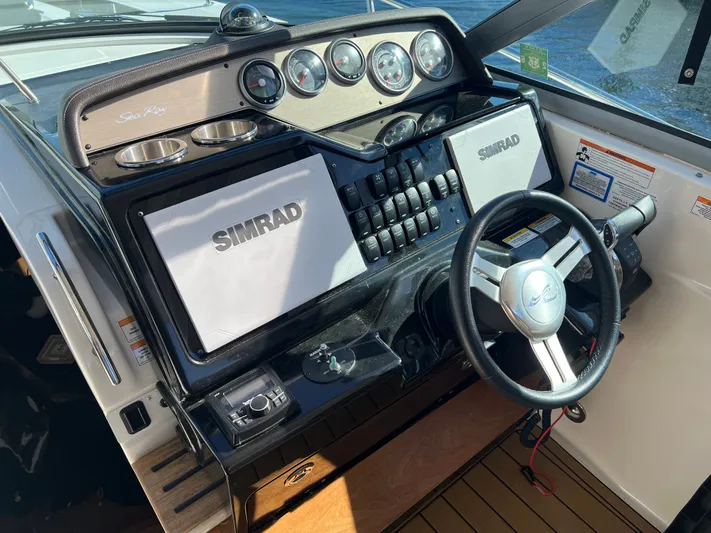  Yacht Photos Pics 2018 Sea Ray 350 Sundancer helm with Simrad electronics and sleek steering wheel.