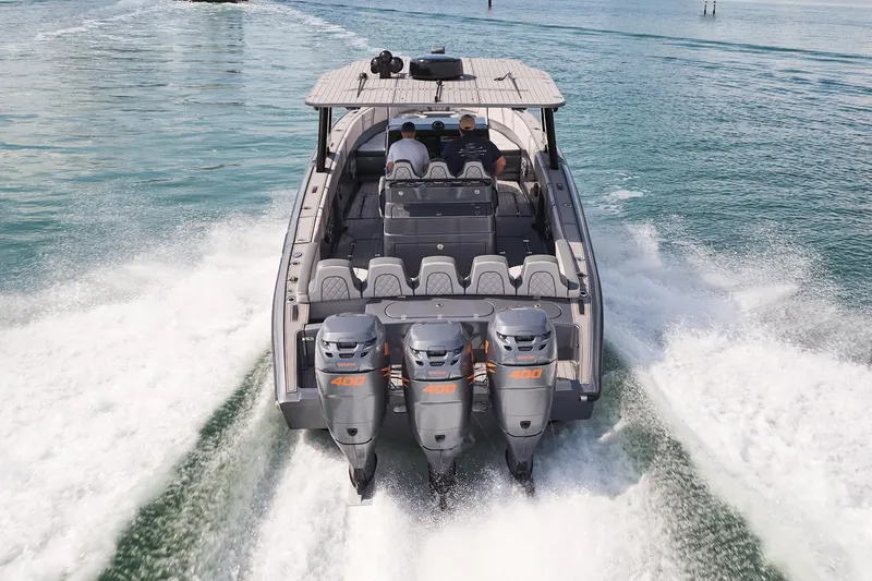  Yacht Photos Pics 2023 Midnight Express 37' Open boat with triple engines cruising on water.
