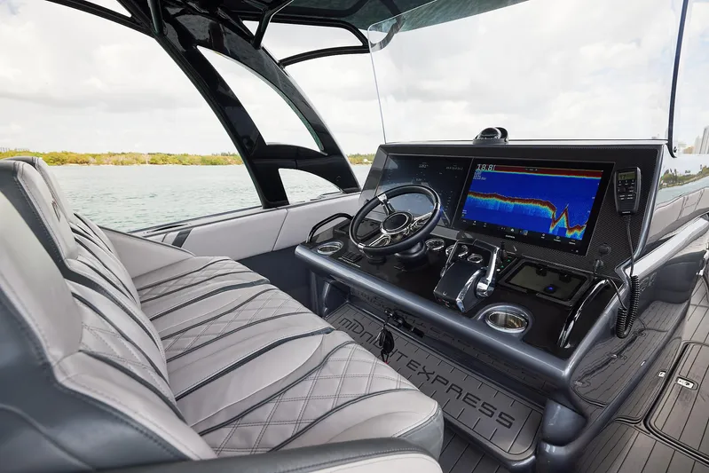  Yacht Photos Pics 2023 Midnight Express 37' Open boat interior with advanced navigation system and luxurious seating.