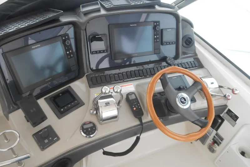  Yacht Photos Pics Control panel of 2007 Sea Ray 44 Sundancer with steering wheel and navigation screens.