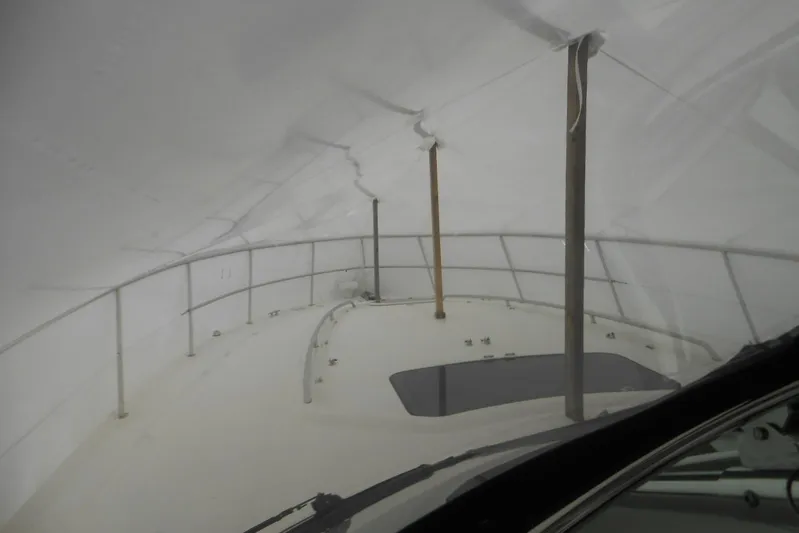  Yacht Photos Pics 2007 Sea Ray 44 Sundancer yacht under protective cover, showcasing deck and railings.