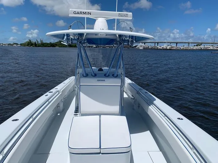  Yacht Photos Pics 2021 Contender 35 ST boat on water, featuring Garmin equipment, clear skies, and distant bridge.