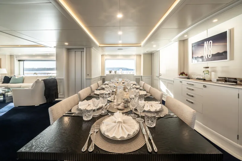 Moatize Yacht Photos Pics Luxurious dining area on a 1998 Pendennis Custom yacht, elegantly set table with ocean view.
