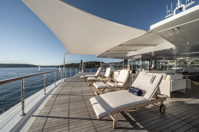 Moatize Yacht Photos Pics Luxurious Pendennis Custom yacht deck with sun loungers, ocean view, and shade canopy, built in 1998.