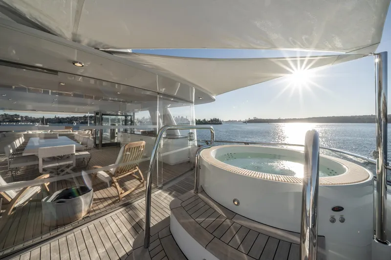 Moatize Yacht Photos Pics Luxurious Pendennis Custom yacht deck with jacuzzi, sunlit seating area, and ocean view, built in 1998.