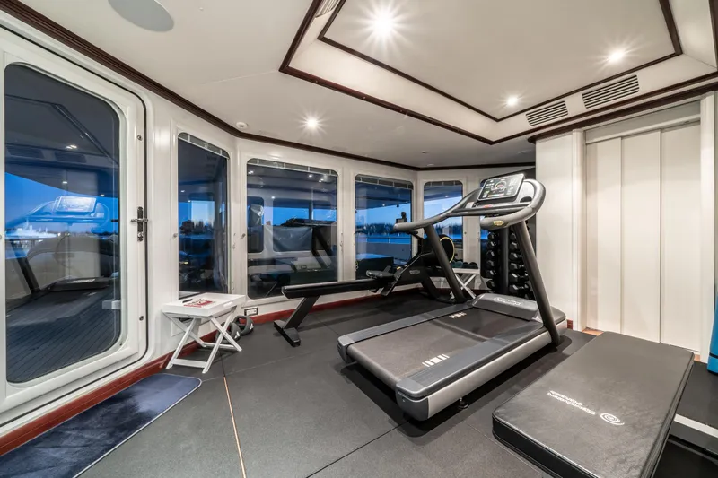 Moatize Yacht Photos Pics Luxurious yacht gym with treadmill, weights, and panoramic windows on a 1998 Pendennis Custom.