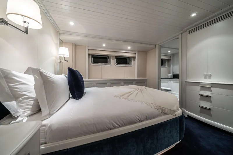 Moatize Yacht Photos Pics Luxurious bedroom interior on 1998 Pendennis Custom yacht, featuring elegant design and cozy ambiance.