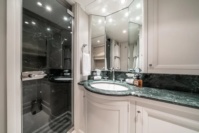 Moatize Yacht Photos Pics Luxurious yacht bathroom with marble countertop and mirrored cabinets, Pendennis Custom 1998.