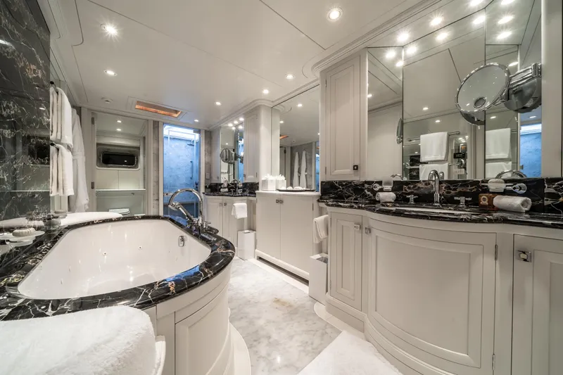 Moatize Yacht Photos Pics Luxurious yacht bathroom with marble accents, elegant fixtures, and ample lighting, Pendennis Custom 1998.