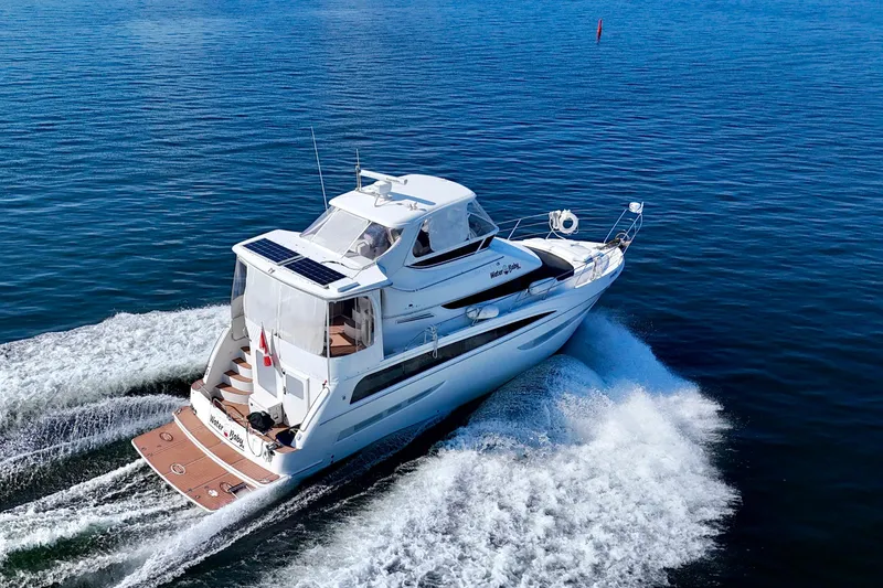 Water Baby Yacht Photos Pics 2007 Carver 43 Motor Yacht cruising on open water, rear view.