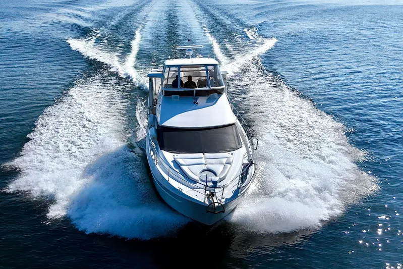 Water Baby Yacht Photos Pics 2007 Carver 43 Motor Yacht cruising on open water, creating a dynamic wake.