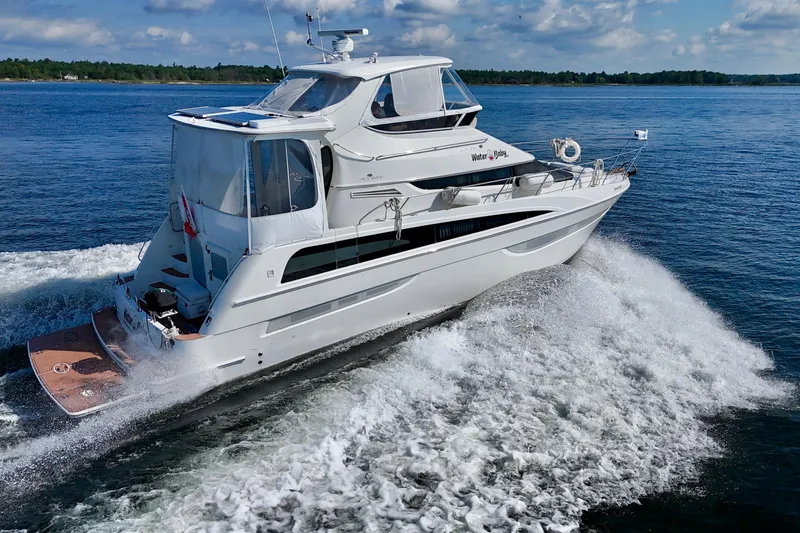 Water Baby Yacht Photos Pics 2007 Carver 43 Motor Yacht cruising on open water under a clear sky.