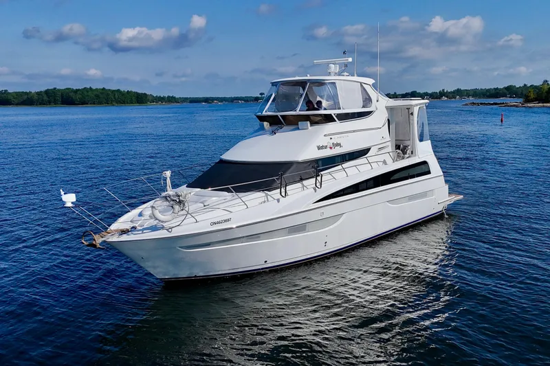 Water Baby Yacht Photos Pics 2007 Carver 43 Motor Yacht cruising on a serene lake under a blue sky.