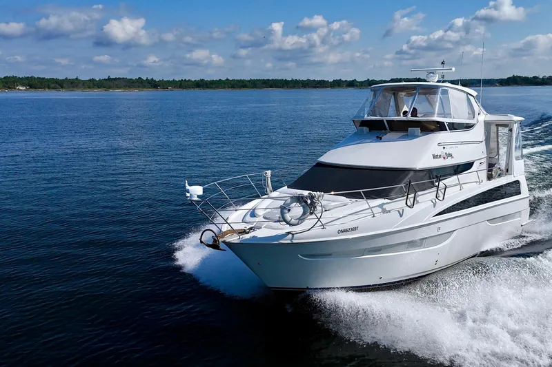 Water Baby Yacht Photos Pics 2007 Carver 43 Motor Yacht cruising on open water under a clear sky.