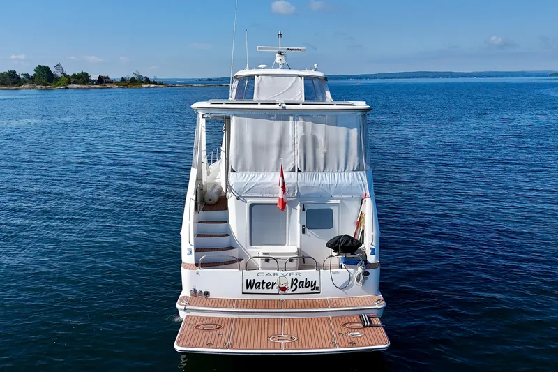 Water Baby Yacht Photos Pics 2007 Carver 43 Motor Yacht on calm blue water, rear view.