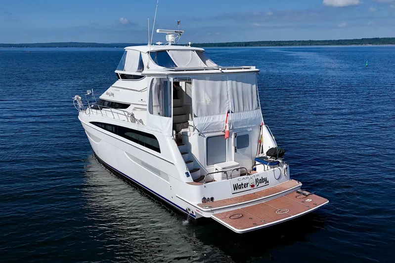 Water Baby Yacht Photos Pics 2007 Carver 43 Motor Yacht on calm blue water, rear view.