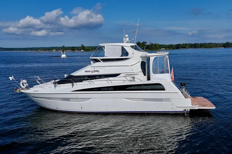 Water Baby Yacht Photos Pics 2007 Carver 43 Motor Yacht on calm water under a clear blue sky.