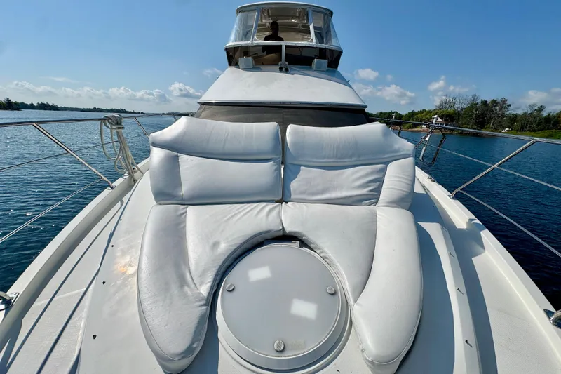 Water Baby Yacht Photos Pics 2007 Carver 43 Motor Yacht with white cushioned seating on deck, cruising on a sunny day.