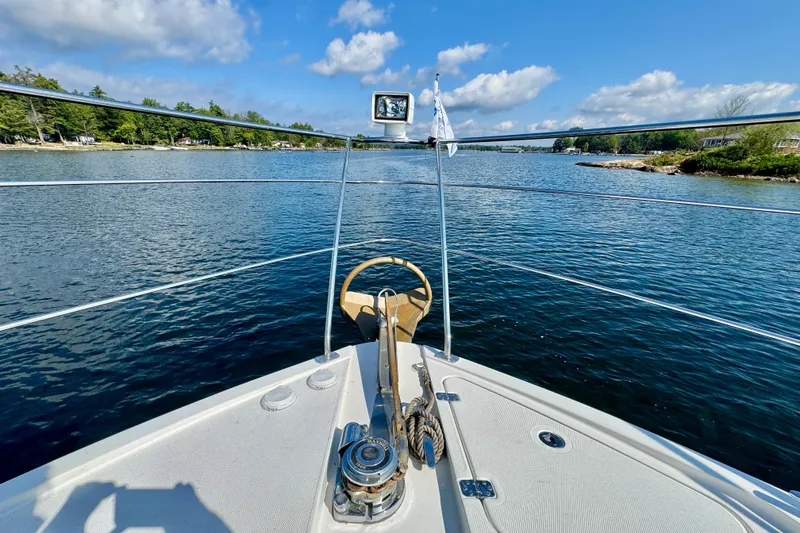 Water Baby Yacht Photos Pics Bow view of 2007 Carver 43 Motor Yacht on serene waterway under blue sky.