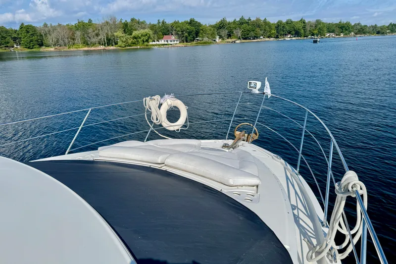 Water Baby Yacht Photos Pics 2007 Carver 43 Motor Yacht on serene lake with lush shoreline.