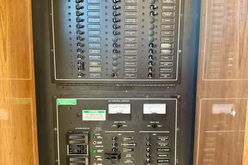 Water Baby Yacht Photos Pics Electrical control panel of a 2007 Carver 43 Motor Yacht, featuring various switches and meters.