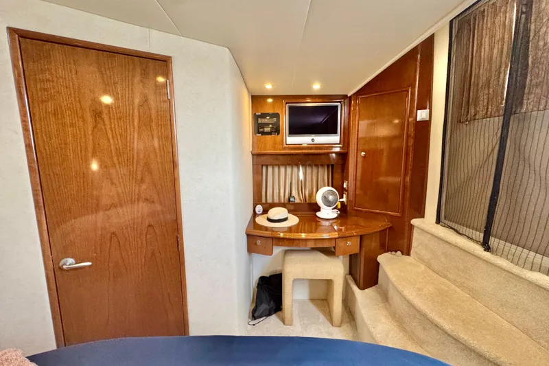 Water Baby Yacht Photos Pics 2007 Carver 43 Motor Yacht interior with wooden cabinetry, desk, and TV.