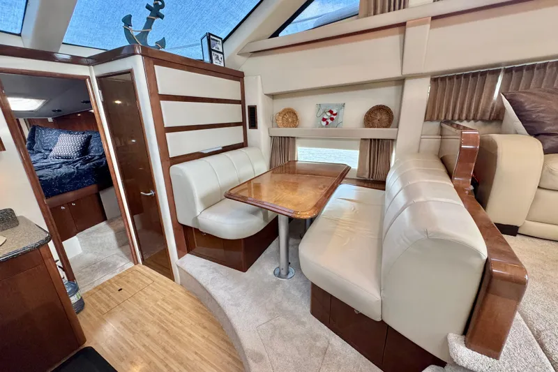 Water Baby Yacht Photos Pics 2007 Carver 43 Motor Yacht interior with dining area and cozy seating.