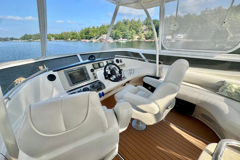 Water Baby Yacht Photos Pics Luxurious 2007 Carver 43 Motor Yacht helm with modern navigation equipment and scenic water view.