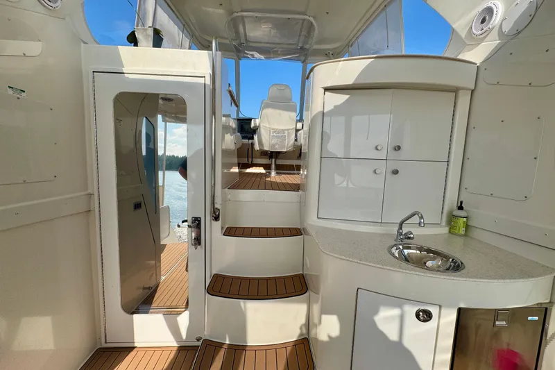 Water Baby Yacht Photos Pics Interior of 2007 Carver 43 Motor Yacht with stairs, sink, and cabinets.