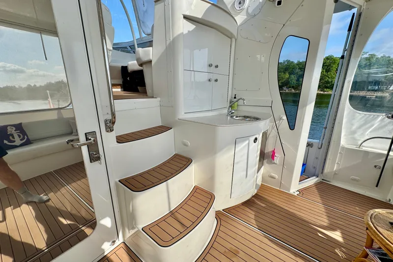 Water Baby Yacht Photos Pics 2007 Carver 43 Motor Yacht interior with wood flooring, kitchenette, and seating area.