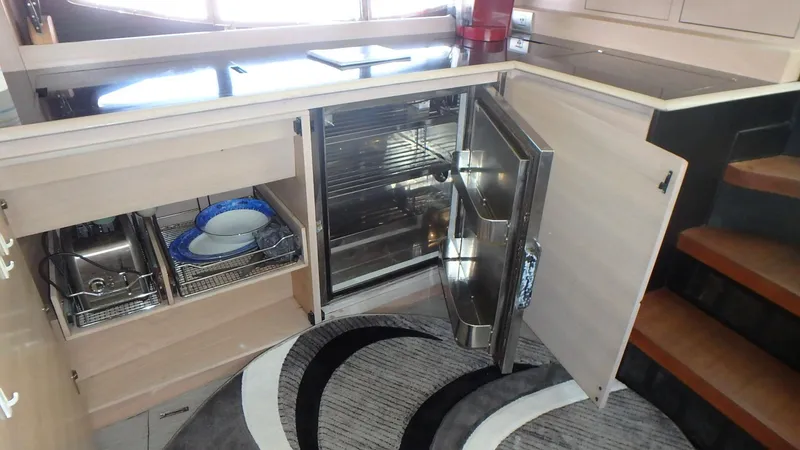 My Way Yacht Photos Pics 2006 Azimut Atlantis 55 yacht kitchen with open fridge and storage cabinets.