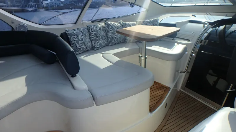 My Way Yacht Photos Pics Luxurious interior of 2006 Azimut Atlantis 55 yacht with plush seating and wooden table.
