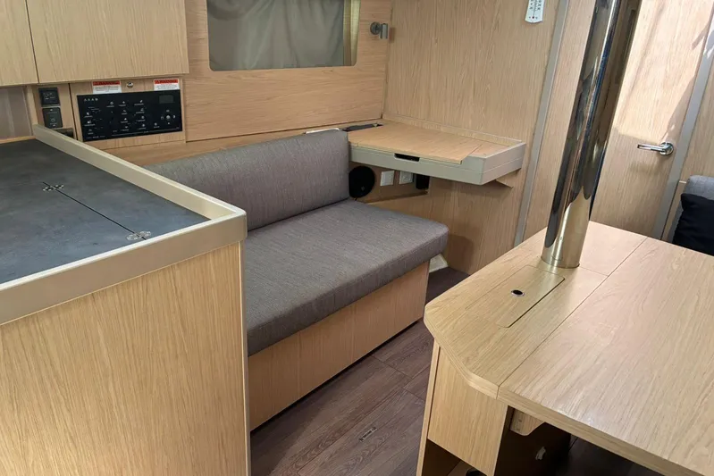 Yacht Photos Pics Interior of 2020 Beneteau Oceanis 41.1 yacht with modern wood finish and seating area.