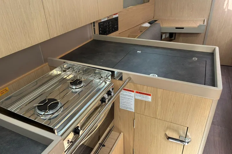  Yacht Photos Pics Modern kitchen in 2020 Beneteau Oceanis 41.1 yacht with stove and sleek cabinetry.