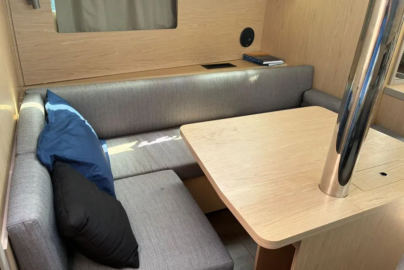  Yacht Photos Pics Interior of 2020 Beneteau Oceanis 41.1 yacht with cozy seating and wooden table.