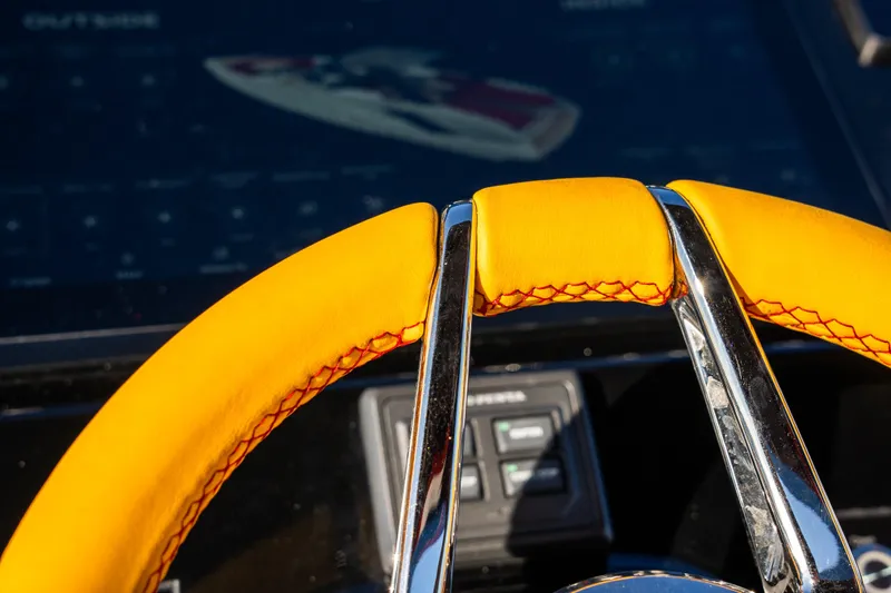  Yacht Photos Pics Yellow steering wheel detail of 2024 Frauscher 1414 Demon boat.