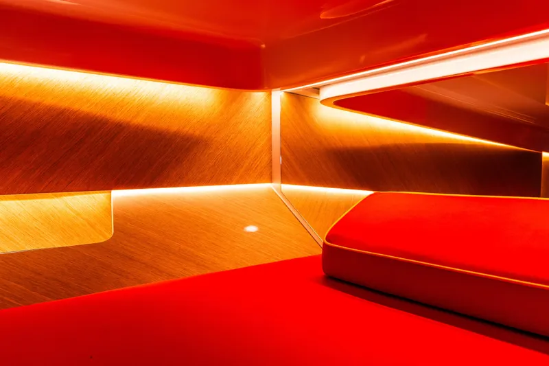  Yacht Photos Pics Luxurious interior of 2024 Frauscher 1414 Demon with vibrant red and warm lighting.