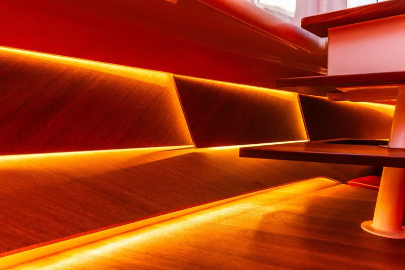  Yacht Photos Pics 2024 Frauscher 1414 Demon interior with warm ambient lighting and sleek wooden design.