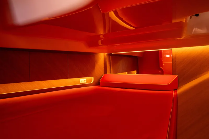  Yacht Photos Pics Luxurious interior of 2024 Frauscher 1414 Demon yacht with vibrant red and wood accents.