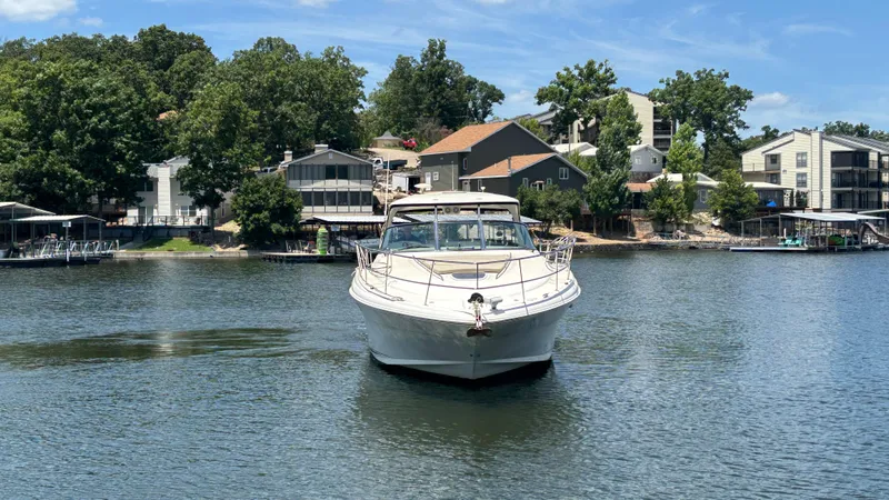  Yacht Photos Pics 2004 Sea Ray 420 Sundancer yacht on a serene lake with waterfront homes.