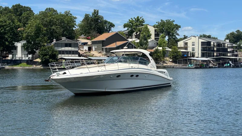  Yacht Photos Pics 2004 Sea Ray 420 Sundancer yacht on a serene lake with waterfront homes.