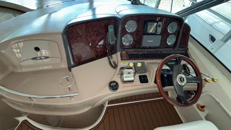  Yacht Photos Pics 2004 Sea Ray 420 Sundancer helm with wood accents and modern controls.