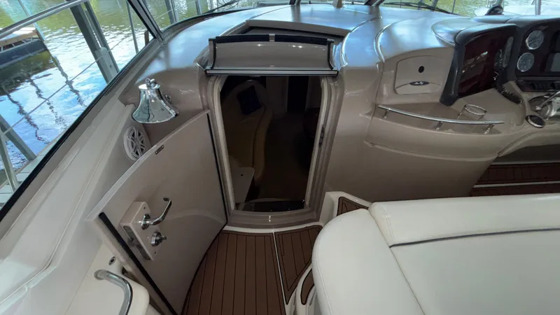  Yacht Photos Pics 2004 Sea Ray 420 Sundancer cockpit with helm, open cabin door, and wood flooring.