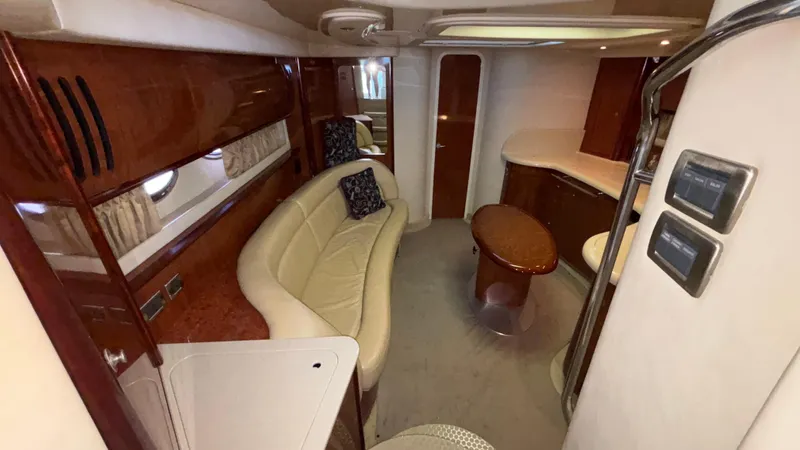  Yacht Photos Pics Luxurious interior of 2004 Sea Ray 420 Sundancer yacht with elegant seating and wood finishes.